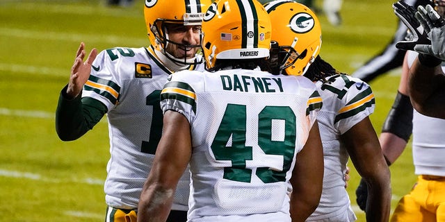 Green Bay Packers' Dominique Dafney is congratulated by quarterback Aaron Rodgers after catching a touchdown pass during the first half of an NFL football game against the Chicago Bears Sunday, Jan. 3, 2021, in Chicago. (AP Photo/Nam Y. Huh)