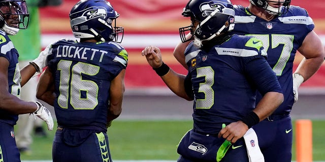 Seattle Seahawks wide receiver Tyler Lockett (16) celebrates his touchdown with quarterback Russell Wilson (3) during the second half of an NFL football game against the San Francisco 49ers, Sunday, Jan. 3, 2021, in Glendale, Ariz. (AP Photo/Ross D. Franklin)
