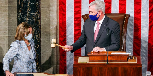 House Minority Leader Kevin McCarthy, R-Calif., gavels in House Speaker Nancy Pelosi, D-Calif., during opening day of the 117th Congress at the U.S. Capitol in Washington, Sunday, Jan. 3, 2021. (Tasos Katopodis/Pool via AP)