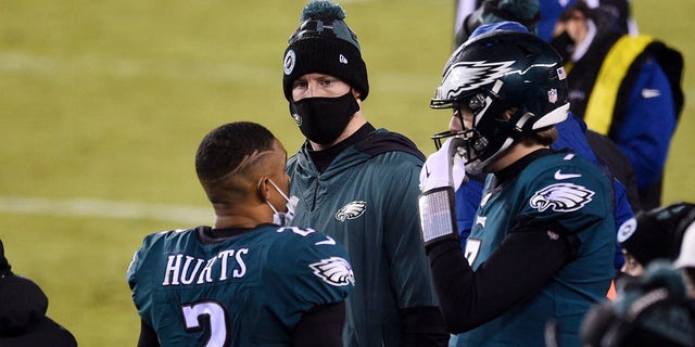 Philadelphia Eagles Jalen Hurts, left to right, Carson Wentz and Nate Sudfeld chat during the second half of an NFL football game against the Washington football team on Sunday, Jan. 3, 2021, in Philadelphia.  (AP Photo / Derik Hamilton)