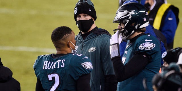 Philadelphia Eagles' Jalen Hurts, from left, Carson Wentz and Nate Sudfeld talk during the second half of an NFL football game against the Washington Football Team, Sunday, Jan. 3, 2021, in Philadelphia. (AP Photo/Derik Hamilton)