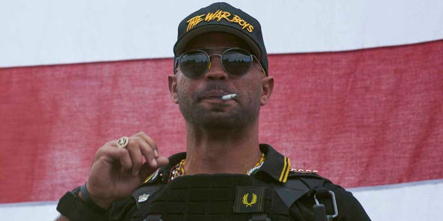 In this Sept. 26, 2020, file photo, Proud Boys leader Henry "Enrique" Tarrio wears a hat that says The War Boys during a rally in Portland, Ore. Police in the nation’s capital on Jan. 4, 2021, arrested the leader of the Proud Boys, who is accused of burning a Black Lives Matter banner that was torn down from a historic Black church in downtown Washington in December 2020. (AP Photo/Allison Dinner, File)