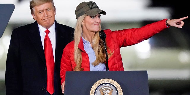 Sen. Kelly Loeffler, R-Ga., speaks as President Donald Trump listens during a campaign rally in support of Senate candidates Loeffler and David Perdue in Dalton, Ga., Monday, Jan. 4, 2021. (AP Photo/Brynn Anderson)