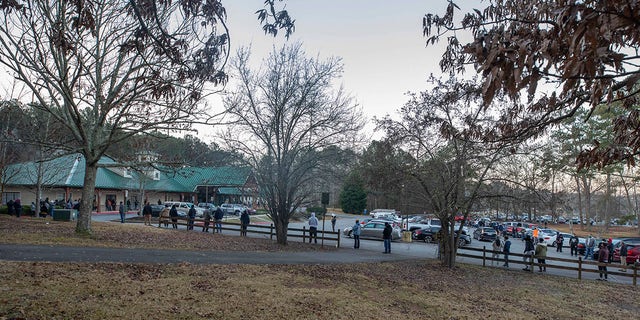 Voters wait in line to cast their ballots in Georgia's Senate runoff elections at a senior center, Tuesday, Jan. 5, 2021, in Acworth, Ga. (AP Photo/Branden Camp)