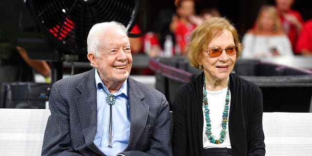 Former President Jimmy Carter and Rosalynn Carter are seen ahead of an NFL football game between the Atlanta Falcons and the Cincinnati Bengals