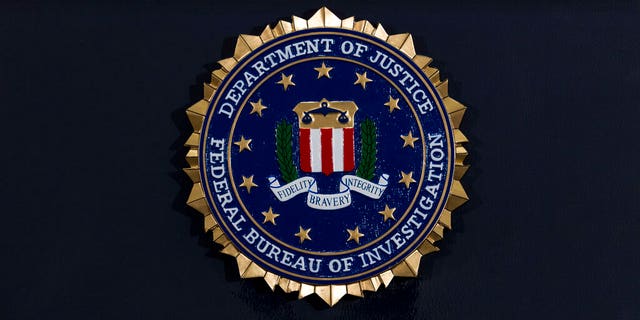 The FBI seal is seen before a news conference at FBI headquarters in Washington