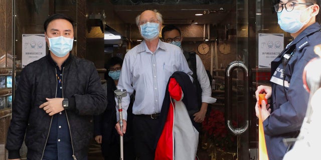 American human rights lawyer John Clancey, center, is arrested by police in Hong Kong Wednesday, Jan. 6, 2021. (Associated Press)