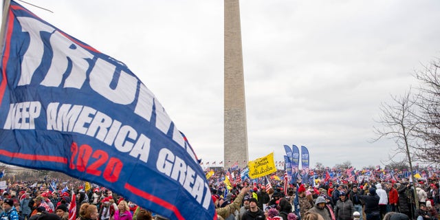 With the Washington Monument in the background, people attend a rally in support of President Donald Trump on Wednesday, Jan. 6, 2021, in Washington. (AP Photo/Jose Luis Magana)
