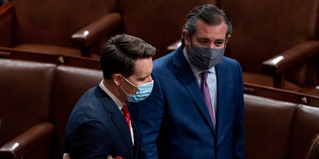 Sen. Josh Hawley, R-Mo., left, and Sen. Ted Cruz, R-Texas, right, speak after Republicans objected to certifying the Electoral College votes from Arizona, during a joint session of the House and Senate to confirm the electoral votes cast in November's election, at the Capitol, Wednesday, Jan 6, 2021. (AP Photo/Andrew Harnik)