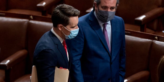 Sen. Josh Hawley, R-Mo., left, and Sen. Ted Cruz, R-Texas, right, speak after Republicans objected to certifying the Electoral College votes from Arizona, during a joint session of the House and Senate to confirm the electoral votes cast in November's election, at the Capitol, Wednesday, Jan 6, 2021. (AP Photo/Andrew Harnik)