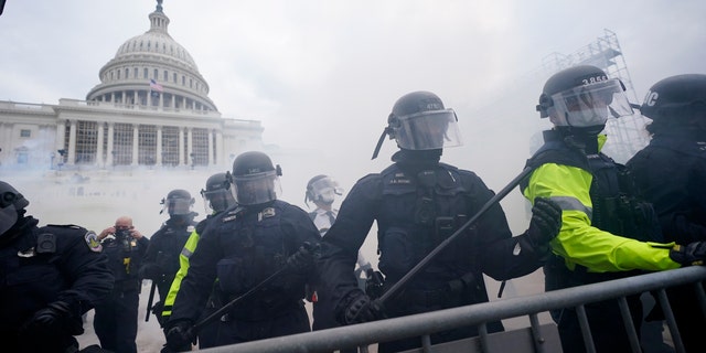 Police stand guard after holding off Trump supporters who tried to break through a police barrier, Wednesday, Jan. 6, 2021, at the Capitol in Washington. (AP Photo/Julio Cortez)