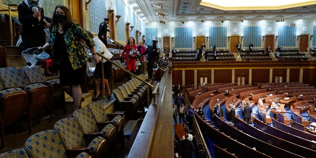 People shelter in the House gallery as protesters try to break into the House Chamber at the U.S. Capitol on Wednesday, Jan. 6, 2021, in Washington. (AP Photo/Andrew Harnik)