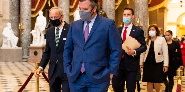 Sen. Ted Cruz, R-Texas, front, followed by Sen. Josh Hawley, R-Mo., walks from the House Chamber during a joint session to confirm the Electoral College votes on Wednesday, Jan. 6, 2021, in Washington. (AP Photo/Manuel Balce Ceneta)