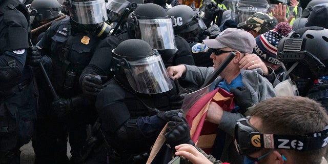 Capitol Police officers in riot gear push back as demonstrators try to break a door of the U.S. Capitol on Wednesday, Jan. 6, 2021, in Washington. (Associated Press)