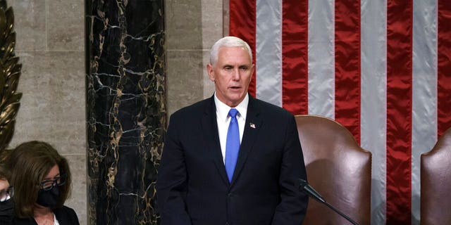 Vice President Mike Pence listens after reading the final certification of Electoral College votes cast in November's presidential election during a joint session of Congress after working through the night, at the Capitol in Washington, Jan. 7. 