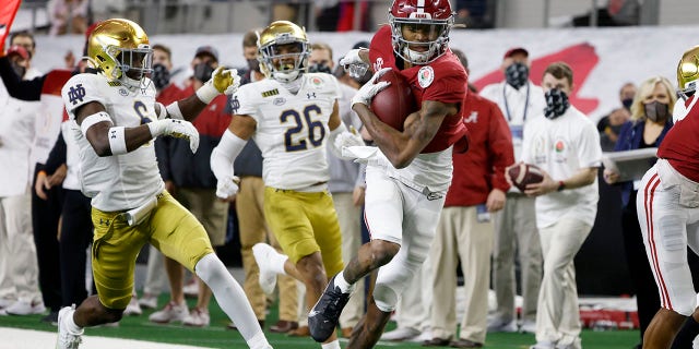 Alabama wide receiver DeVonta Smith (6) gets past Notre Dame linebacker Jeremiah Owusu-Koramoah (6) and cornerback Clarence Lewis (26) on his way to the end zone for a touchdown in the first half of the Rose Bowl NCAA college football game in Arlington, Texas, in this Friday, Jan. 1, 2021, file photo. (AP Photo/Michael Ainsworth, File)