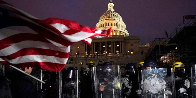 Police stand guard after a day of riots at the U.S. Capitol in Washington on Wednesday, Jan. 6, 2021. (Associated Press)