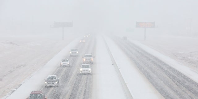 Vehicles driving in the snow on the southbound of Highway 6 Sunday, Jan. 10, 2021, in College Station, Texas. (Yi-Chin Lee/Houston Chronicle via AP)