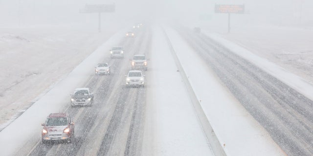 Vehicles driving in the snow on the southbound of Highway 6 Sunday, Jan. 10, 2021, in College Station, Texas. (Yi-Chin Lee/Houston Chronicle via AP)