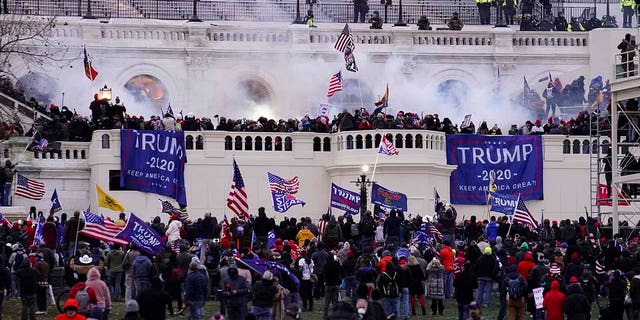On Wednesday, Jan.6, 2021, a file photo of violent protesters storming the Capitol in Washington, DC, federal prosecutors say a retired Air Force officer who was part of the mob that stormed the U.S. Capitol was arrested Sunday, Jan.10, 2021, in Texas.  (AP Photo / John Minchillo, file)