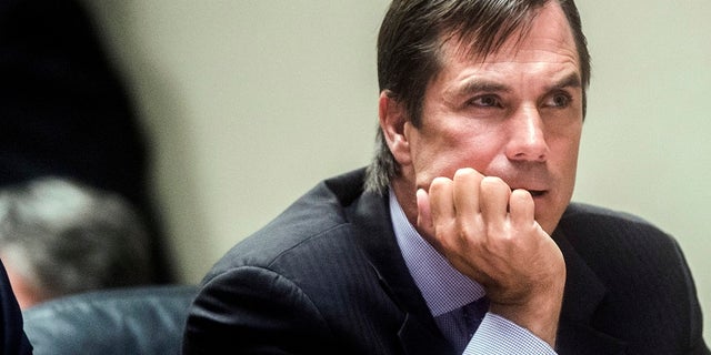 In this Aug. 20, 2018, file photo, Nick Lyon, former director of the Michigan Department of Health and Human Services, listens during Lyon's preliminary examination at Genesee District Court in Flint, Mich. (Jake May/The Flint Journal via AP, File)