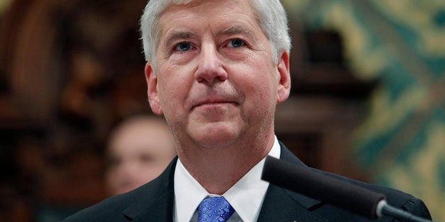 In this Jan. 23, 2018, file photo, former Michigan Gov. Rick Snyder delivers his State of the State address at the state Capitol in Lansing, Mich. Snyder, Nick Lyon, former director of the Michigan Department of Health and Human Services, and other ex-officials have been told they're being charged after a new investigation of the Flint water scandal, which devastated the majority Black city with lead-contaminated water and was blamed for a deadly outbreak of Legionnaires' disease in 2014-15, The Associated Press has learned. (AP Photo/Al Goldis, File)