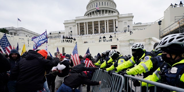 President Trump supporters try to break through a police barrier at the Capitol in Washington, D.C., on Jan. 6, 2021. (AP Photo/Julio Cortez, File)