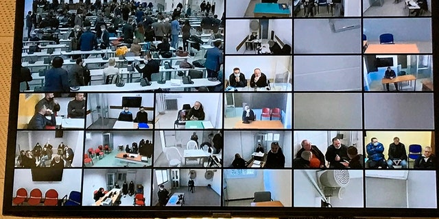A screen anchored to the ceiling shows the participants following the first hearing of a maxi-trial against more than 300 defendants of the ‘ndrangheta crime syndicate in a specially constructed bunker near the Calabrian town of Lamezia Terme, southern Italy, Wednesday, Jan. 13, 2021. (AP Photo/Gianfranco Stara)