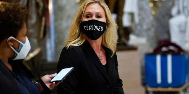 Rep. Marjorie Taylor Greene, R-Ga., walks on Capitol Hill in Washington, Wednesday, Jan. 13, 2021. (AP Photo/Susan Walsh)