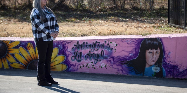 Donna Williams waits to approach the podium, Wednesday, Jan. 13, 2021, in Arlington, Texas, to speak on the 25th anniversary of the abduction and subsequent murder of her daughter, Amber Hagerman, depicted in the mural on the right. (Associated Press)