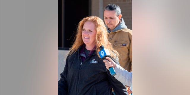 Jenny Cudd, front, a flower shop owner and former Midland mayoral candidate, and Eliel Rosa leave the federal courthouse in Midland, Texas, Wednesday, Jan. 13, 2021. The FBI arrested Cudd and Rosa on Wednesday in connection with the Jan. 6 insurrection at the U.S Capitol. (Tim Fischer/Reporter-Telegram via AP)