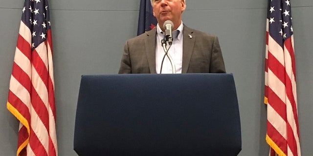 In this Tuesday, Sept. 25, 2018, file photo, then-Michigan Gov. Rick Snyder speaks with reporters during a news conference at his office in Lansing, Mich. Snyder has been charged with two counts of willful neglect of duty in the Flint water crisis. (AP Photo/David Eggert, File)