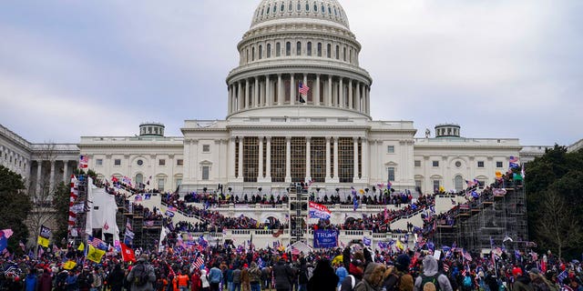This file photo from Wednesday Jan. 6, 2021, shows Trump supporters swarming the Capitol, as Congress prepares to affirm then-President-elect Joe Biden's victory. (AP Photo/John Minchillo, File)