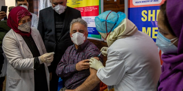 A Kashmiri doctor receives a COVID-19 vaccine at a government Hospital in Srinagar, Indian controlled Kashmir, Saturday, Jan. 16, 2021. India started inoculating health workers Saturday in what is likely the world's largest COVID-19 vaccination campaign, joining the ranks of wealthier nations where the effort is already well underway. (AP Photo/ Dar Yasin)
