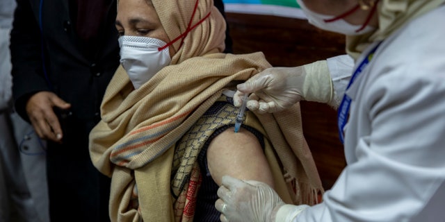 A hospital staff receives a COVID-19 vaccine at a government Hospital in Srinagar, Indian controlled Kashmir, Saturday, Jan. 16, 2021. India started inoculating health workers Saturday in what is likely the world's largest COVID-19 vaccination campaign, joining the ranks of wealthier nations where the effort is already well underway. (AP Photo/ Dar Yasin)