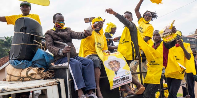 Supporters of Ugandan President Yoweri Kaguta Museveni celebrate in Kampala, Uganda, Saturday Jan. 16, 2021, after their candidate was declared winner of the presidential elections. Uganda’s electoral commission says longtime President Yoweri Museveni has won a sixth term, while top opposition challenger Bobi Wine alleges rigging and officials struggle to explain how polling results were compiled amid an internet blackout. In a generational clash widely watched across the African continent, the young singer-turned-lawmaker Wine posed arguably the greatest challenge yet to Museveni. (AP Photo/Jerome Delay)