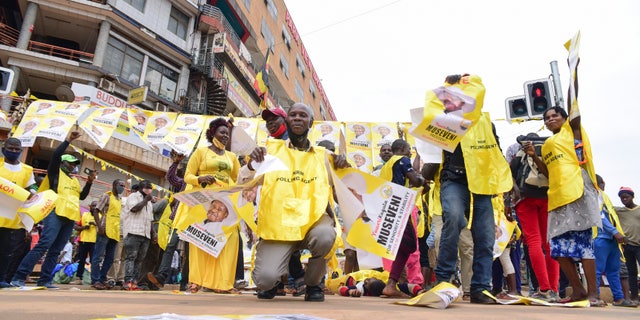 Supporters of Ugandan President Yoweri Kaguta Museveni celebrate, in Kampala, Uganda, Saturday Jan. 16, 2021, after their candidate was declared winner of the presidential elections. Uganda’s electoral commission says longtime President Yoweri Museveni has won a sixth term, while top opposition challenger Bobi Wine alleges rigging and officials struggle to explain how polling results were compiled amid an internet blackout. In a generational clash widely watched across the African continent, the young singer-turned-lawmaker Wine posed arguably the greatest challenge yet to Museveni. (AP Photo/Nicholas Bamulanzeki)