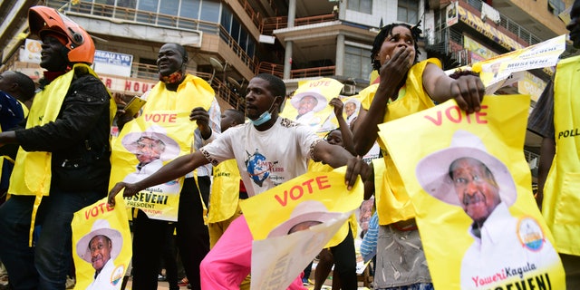 Supporters of Ugandan President Yoweri Kaguta Museveni celebrate, in Kampala, Uganda, on Saturday, Jan. 16, 2021, after their candidate was declared the winner of the presidential election. (AP Photo/Nicholas Bamulanzeki)