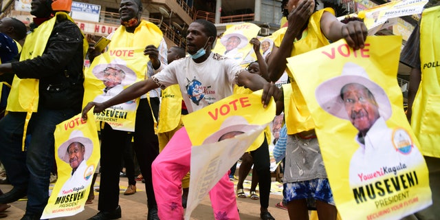 Supporters of Ugandan President Yoweri Kaguta Museveni celebrate, in Kampala, Uganda, on Saturday, Jan. 16, 2021, after their candidate was declared the winner of the presidential election. (AP Photo/Nicholas Bamulanzeki)