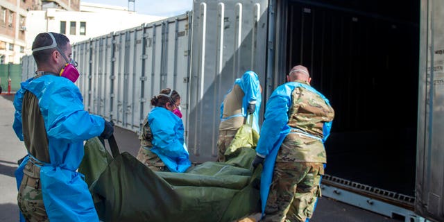 Members of the National Guard are helping process deaths from COVID-19 and place them in temporary storage at the LA County Medical Examiner's Office in Los Angeles, Jan.12, 2021.