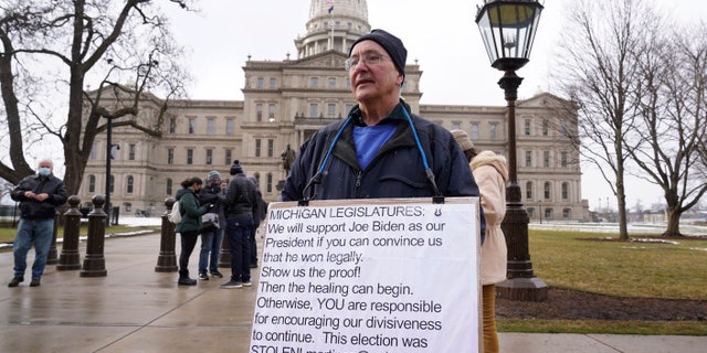 Martin Szelag stands outside the state capitol in Lansing, Mich., Sunday, Jan. 17, 2021. (AP Photo/Paul Sancya)