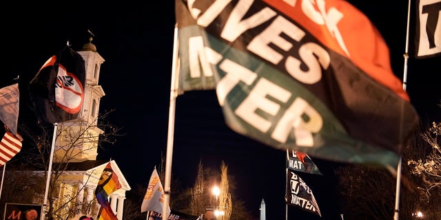 Protesters wave flags in the area known as Black Lives Matter plaza near the White House on Jan. 17. A Norwegian lawmaker has nominated the movement for the 2021 Nobel Peace Prize. (AP Photo/Wong Maye-E)