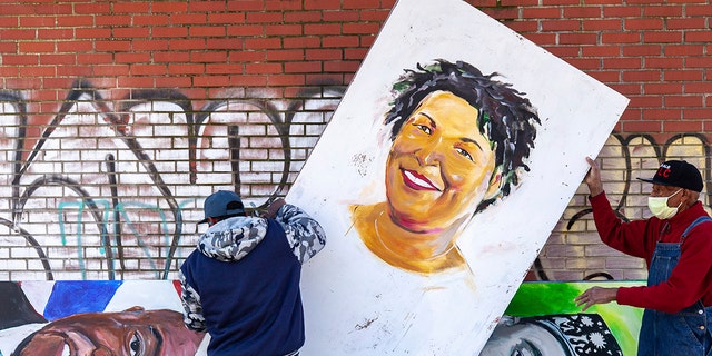 Artists set up a painting of Stacey Abrams in the King Historic District on Monday, Jan. 18, 2021, in honor of Martin Luther King Jr. Day, in Atlanta. (Associated Press)