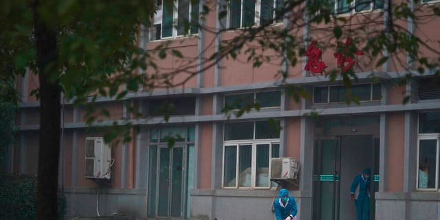 FILE: Hospital staff wash the emergency entrance of Wuhan Medical Treatment Center, where some infected with a new virus are being treated, in Wuhan, China.