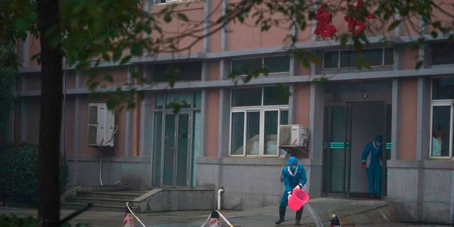 FILE: Hospital staff wash the emergency entrance of Wuhan Medical Treatment Center, where some infected with a new virus are being treated, in Wuhan, China.