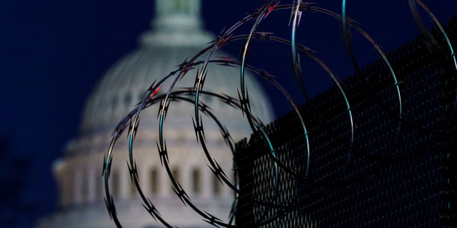 Riot fencing and razor wire reinforce the security zone on Capitol Hill in Washington, Tuesday, Jan. 19, 2021, before President-elect Joe Biden is sworn in as the 46th president on Wednesday. (Associated Press)