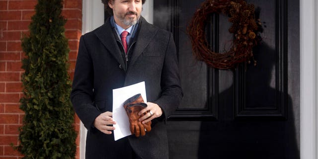 Canadian Prime Minister Justin Trudeau walks to the podium from Rideau cottage for a news conference, Tuesday, Jan. 19, 2021, in Ottawa, Ontario.
