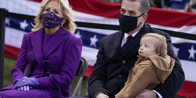 President-elect Joe Biden's wife Jill Biden sits with Hunter Biden and his child during an event at the Major Joseph R. "Beau" Biden III National Guard/Reserve Center, Tuesday, Jan. 19, 2021, in New Castle, Del. (AP Photo/Evan Vucci)