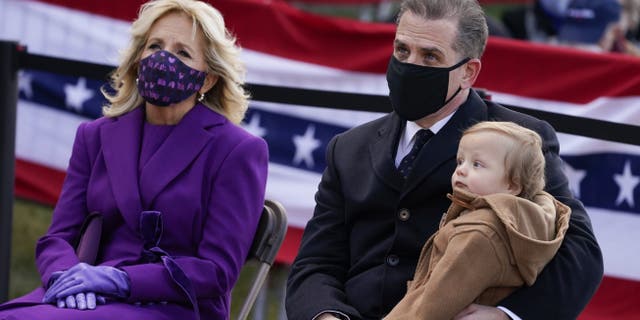 President-elect Joe Biden's wife Jill Biden sits with Hunter Biden and his child during an event at the Major Joseph R. "Beau" Biden III National Guard/Reserve Center, Tuesday, Jan. 19, 2021, in New Castle, Del. (AP Photo/Evan Vucci)