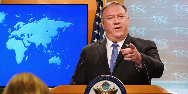 FILE - In this Nov. 10, 2020, file photo, Secretary of State Mike Pompeo gestures toward a reporter while speaking at the State Department in Washington. Pompeo plans to deliver a speech extolling the Trump administration's foreign policy this week in Georgia ahead of key Senate run-off elections that will determine control of the upper chamber of Congress. The accusation of genocide by U.S. Secretary of State Mike Pompeo against China touches on a hot-button human rights issue between China and the West. (AP Photo/Jacquelyn Martin, Pool, File)
